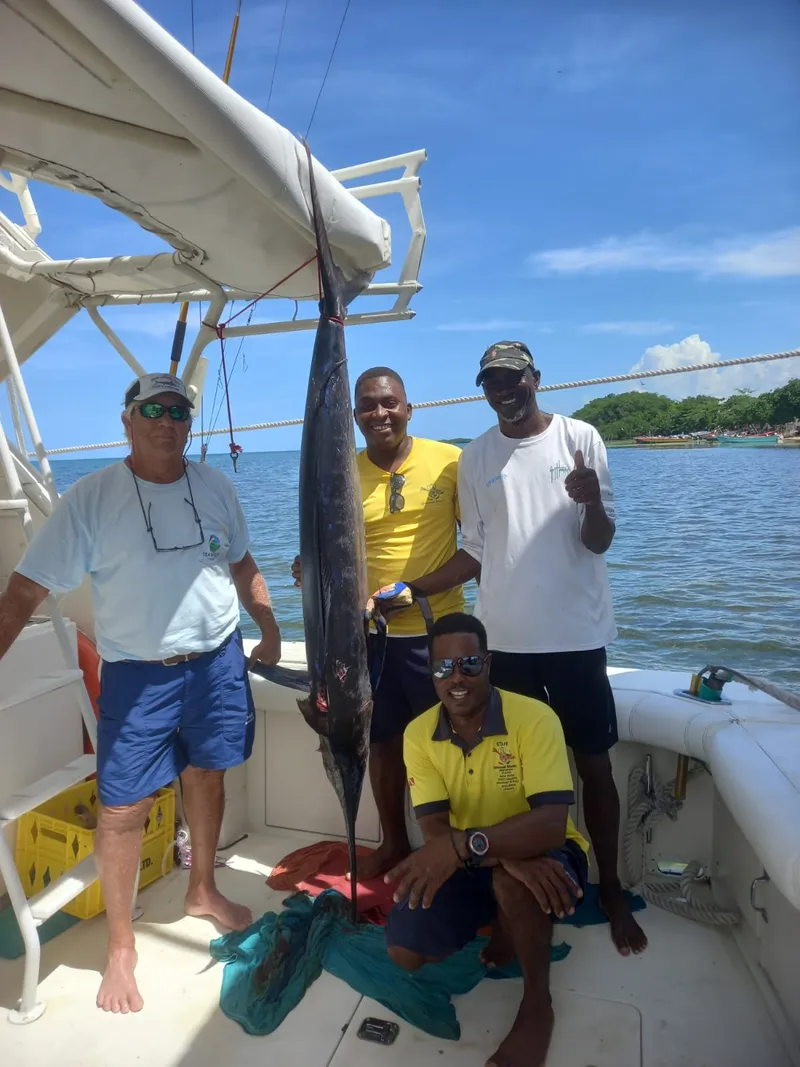 Crew and guests with a marlin caught aboard Vodka Shot off Montego Bay